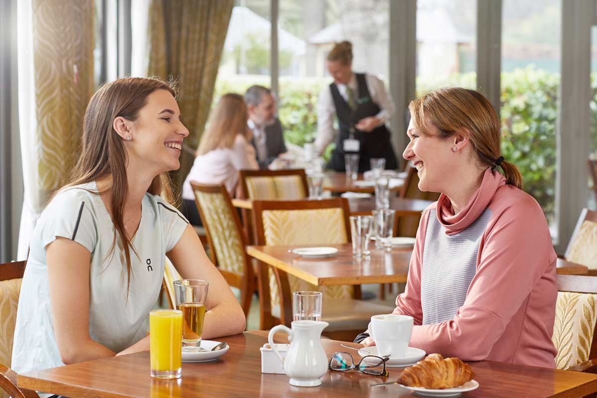 Two ladies enjoying the cafe at St George's Hill Lawn Tennis Club