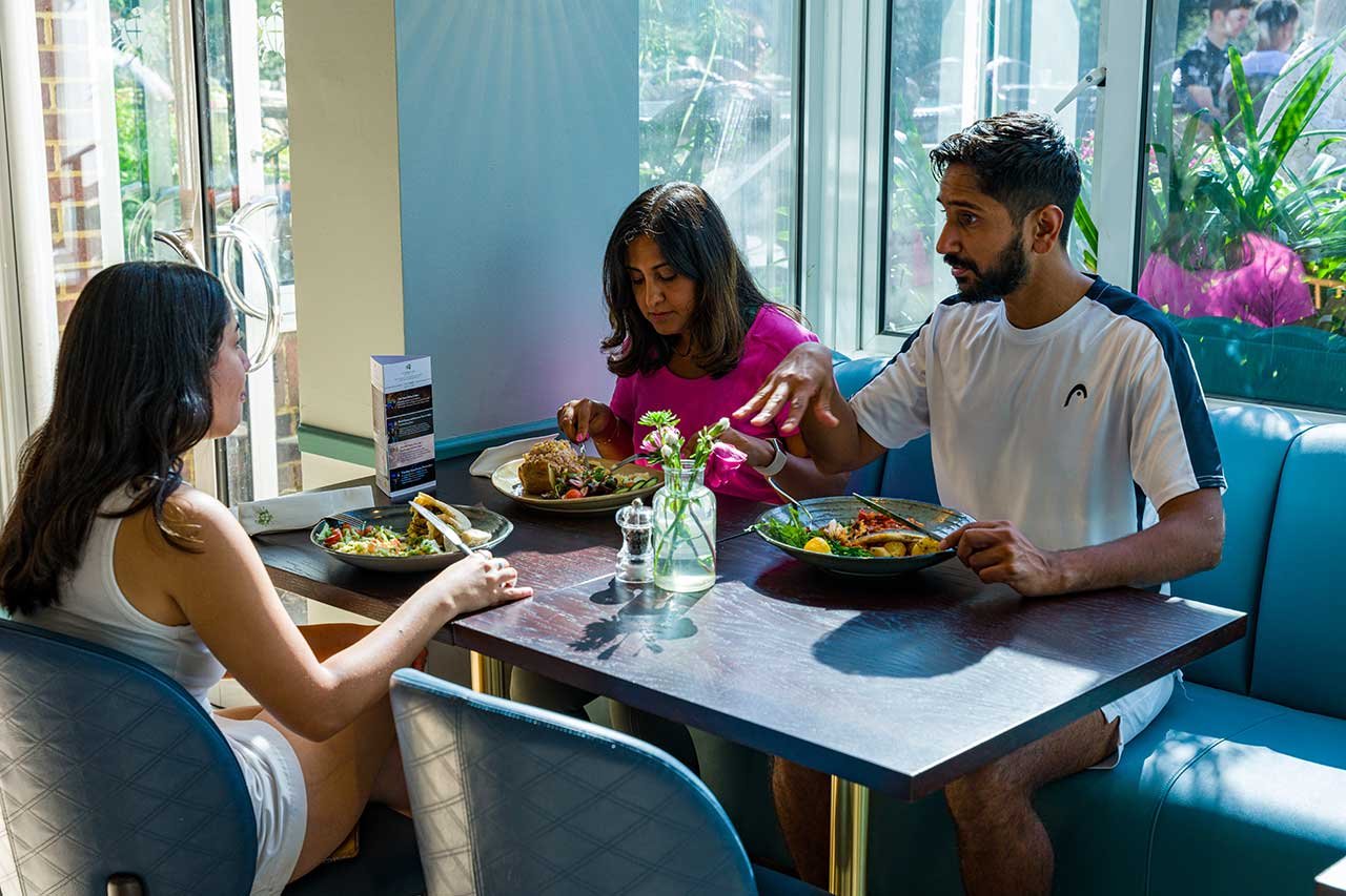 Friends enjoying dining at St George's Hill Lawn Tennis Club