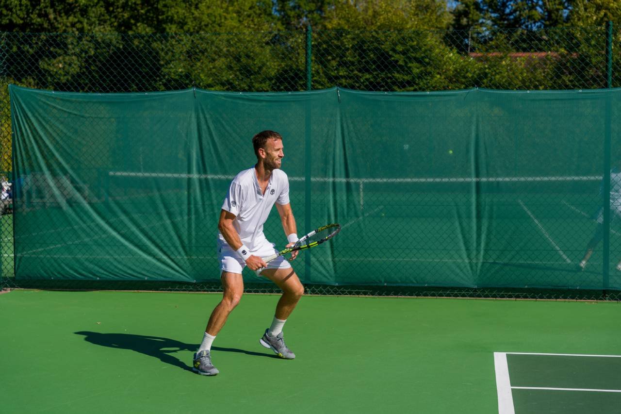Man playing Tennis at St George's Hill Lawn Tennis Club Surrey